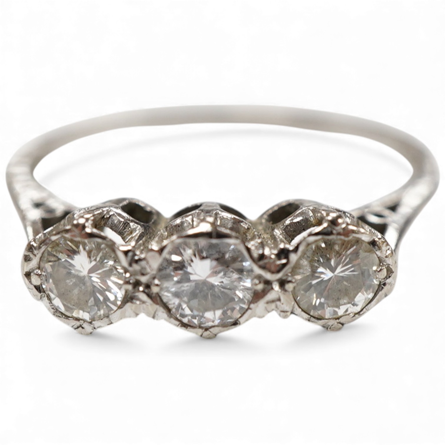 A three-stone diamond ring, set with three brilliant-cut diamonds totalling approximately 0.50 carats, mounted in platinum, size R1/2, British hallmarks, gross weight approximately 4 grams